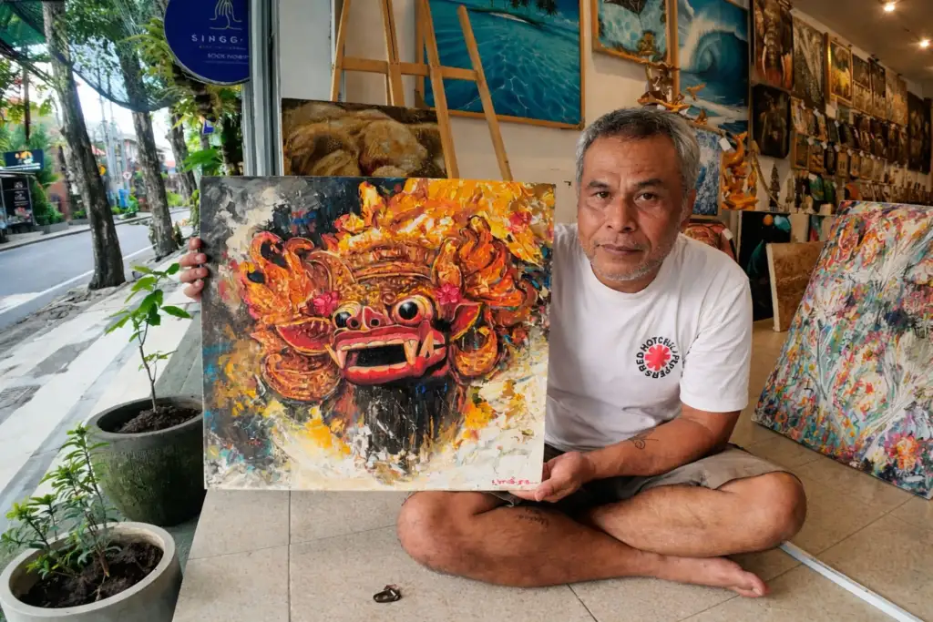 Studio portrait of artist painting. 