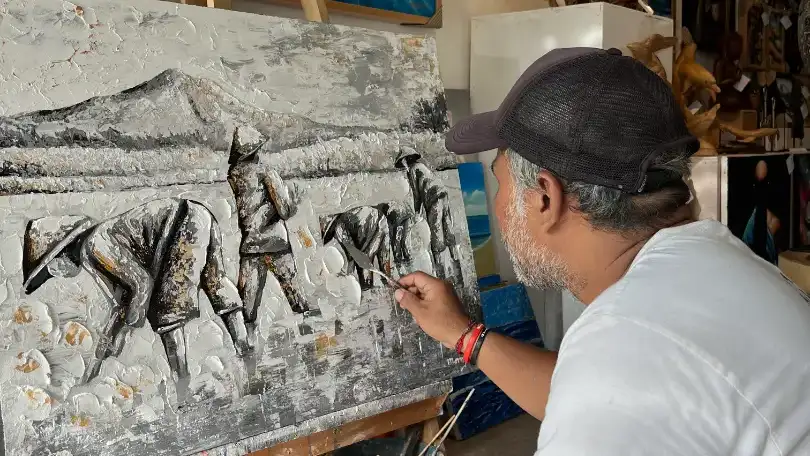 artist from Arts of Bali team working on custom textured painting
