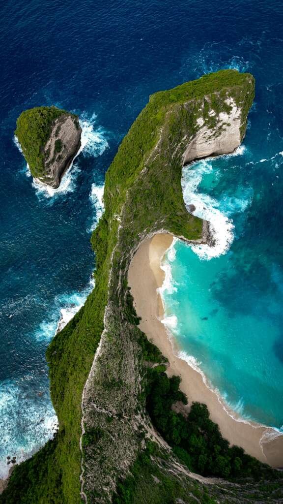 Stunning aerial view of Kelingking Beach's unique rock formation in Bali.