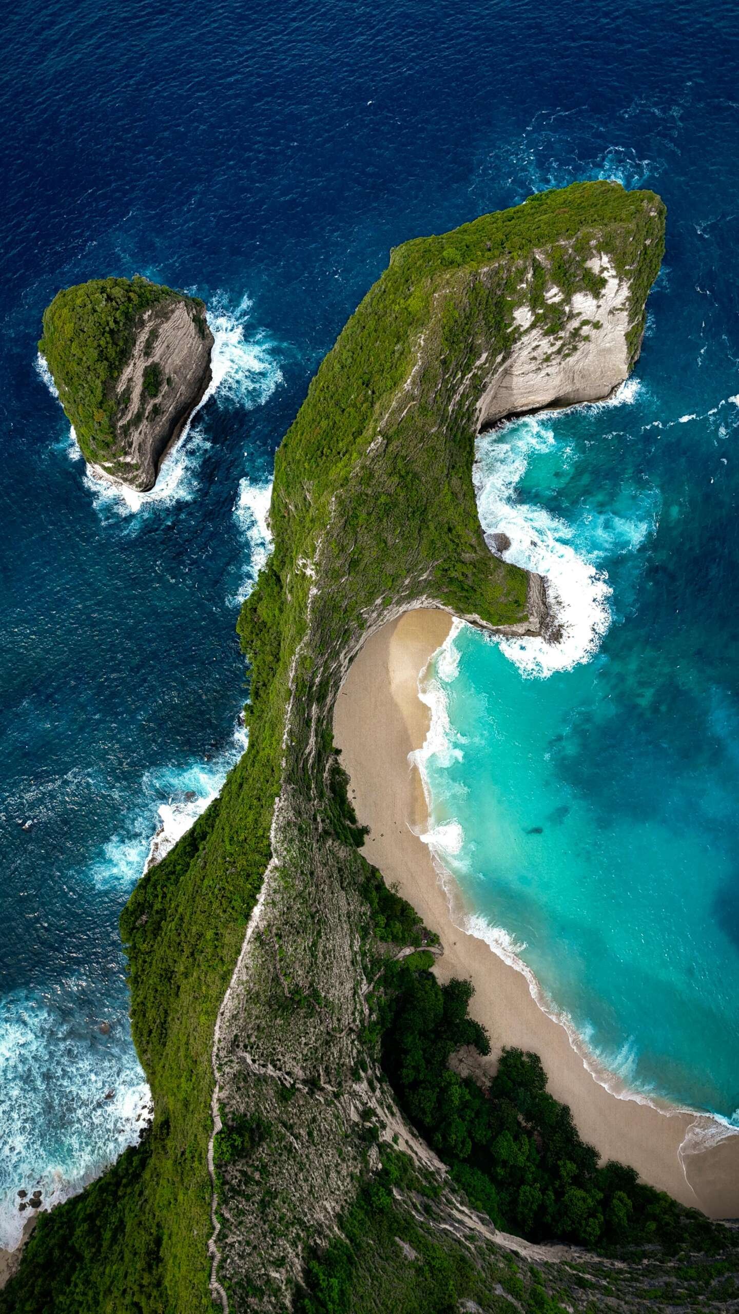 Stunning aerial view of Kelingking Beach's unique rock formation in Bali.