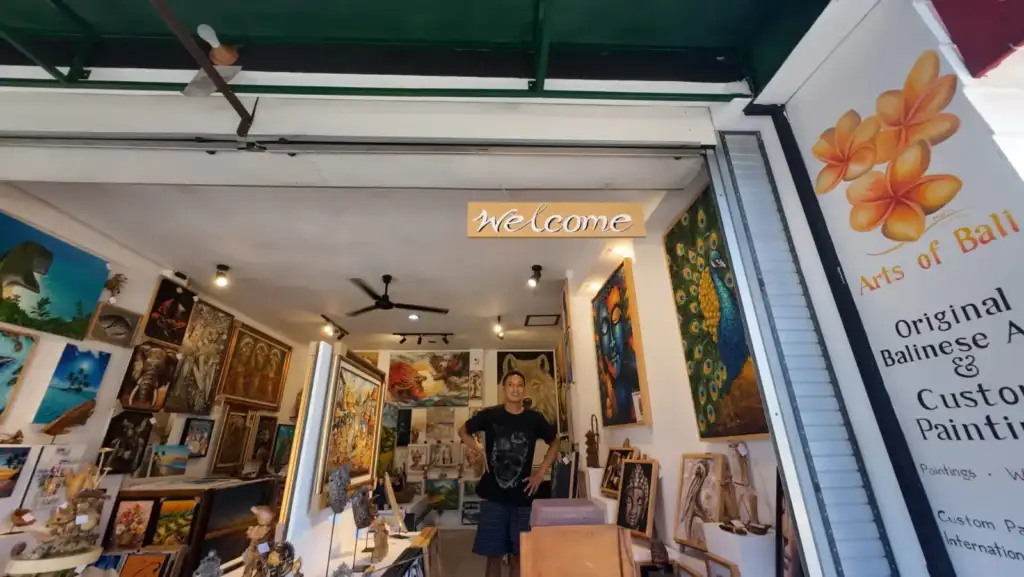 Arts of Bali Balinese art gallery entrance with welcome sign installed and team member standing inside Seminyak