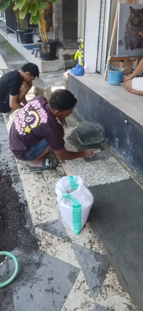 Behind the Display: The Story of Arts of Bali Gallery's New Seminyak Look - Arts of Bali Team of workers installing white pebble wash display area at Arts of Bali gallery - Arts of Bali