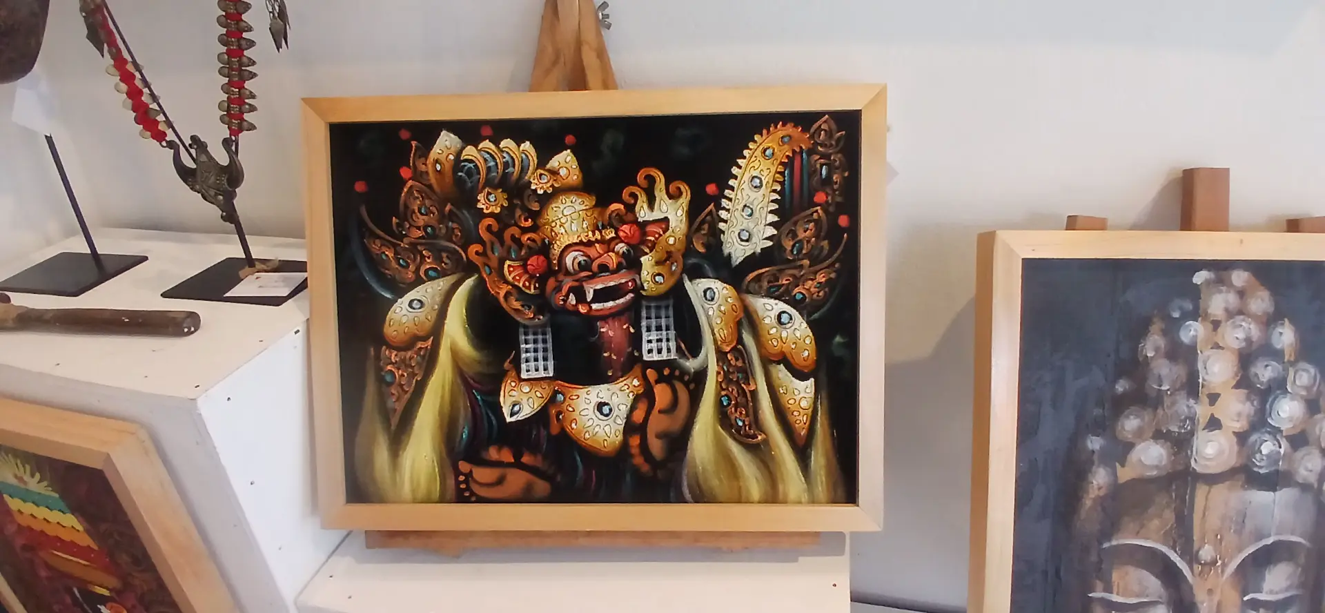 Dramatic oil painting of Barong, the sacred Balinese lion guardian spirit, with intricate golden ornaments against a dark background