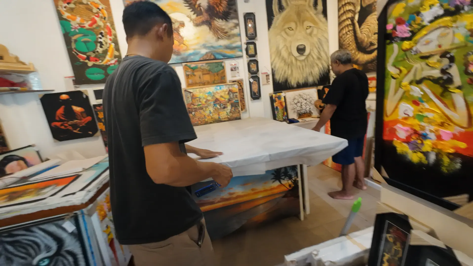 Original art collection at Arts of Bali Seminyak — diverse styles and subjects Rich collection of original paintings covering the walls at Arts of Bali fine art gallery in Seminyak — wolves, abstracts, Balinese scenes, and more