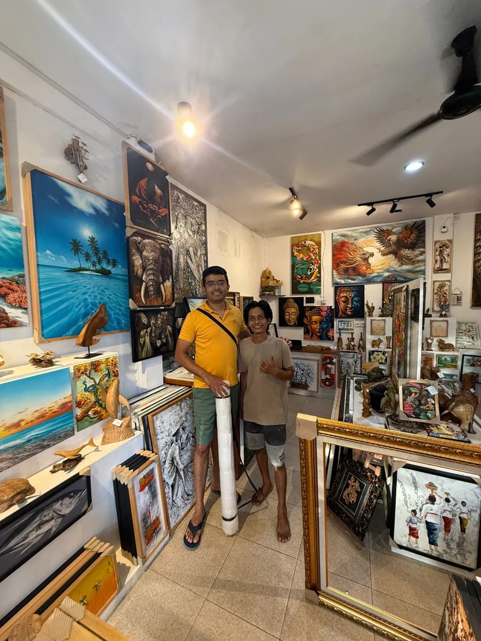 Bali art collector from India posing with Arts of Bali gallery artist