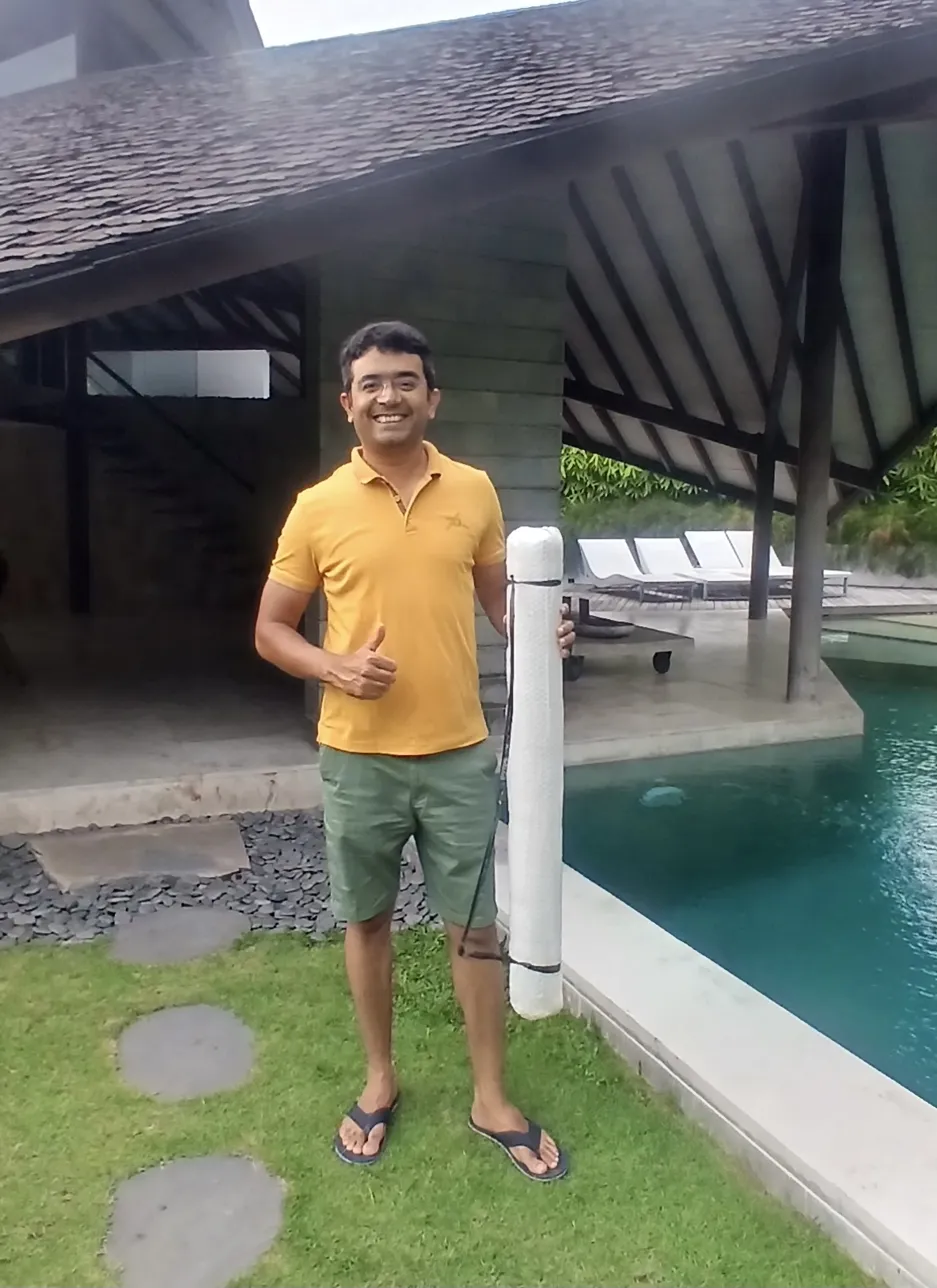 Collector from India receiving bali painting delivered to his luxury villa pool in Bali
