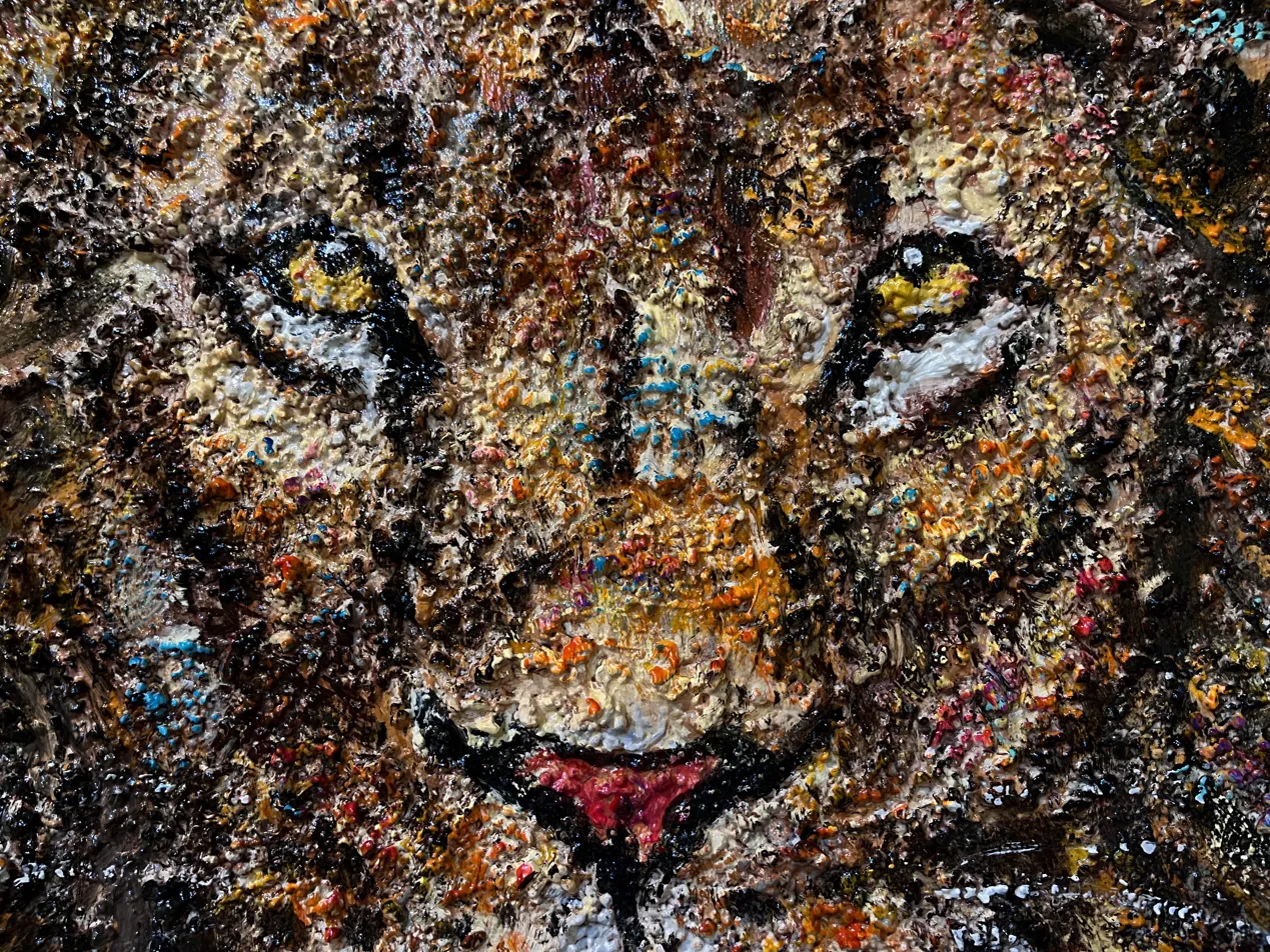 Close-up detail of Farfan's lion sand texture wildlife painting Bali showing the heavily impastoed mixed media surface with amber and dark tones — original artwork Arts of Bali gallery Seminyak