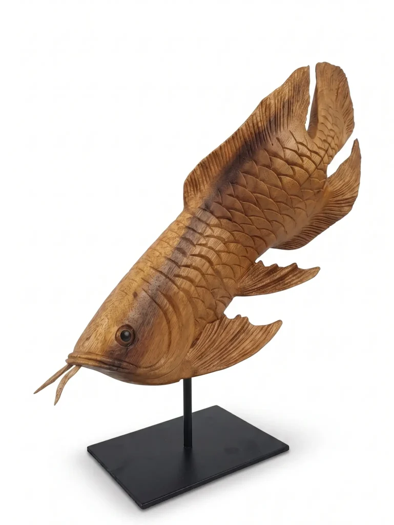 Hand-carved natural wooden arowana fish sculpture mounted on a sleek black stand, Indonesian decorative art Arts of Bali Seminyak