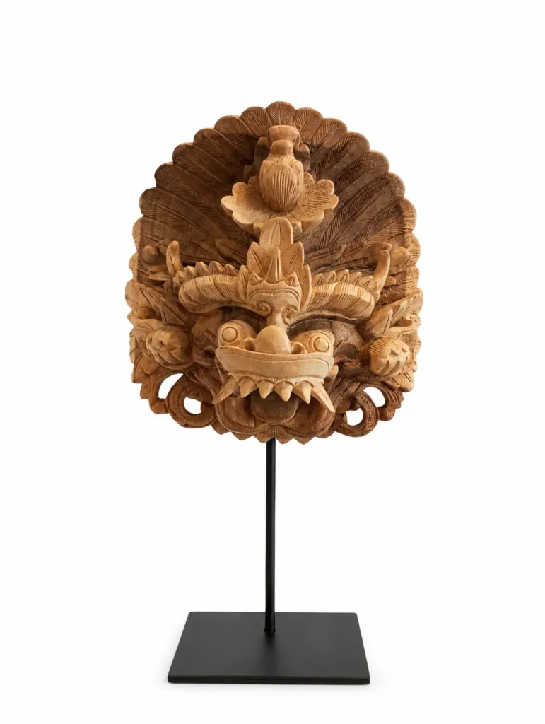 Authentic hand-carved Balinese Barong Sai wooden mask with intricate sunburst crown mounted on a black stand, Indonesian decorative art Arts of Bali Seminyak