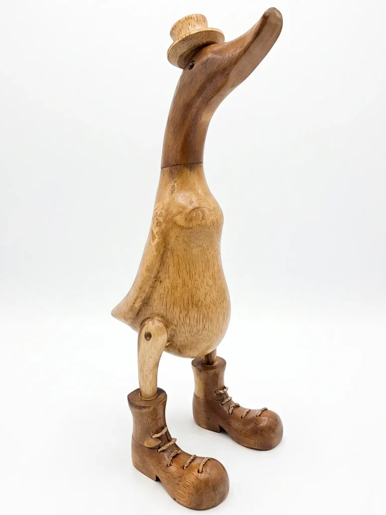 Whimsical hand-carved wooden duck figurine wearing boots and a hat, Indonesian decorative art Arts of Bali Seminyak