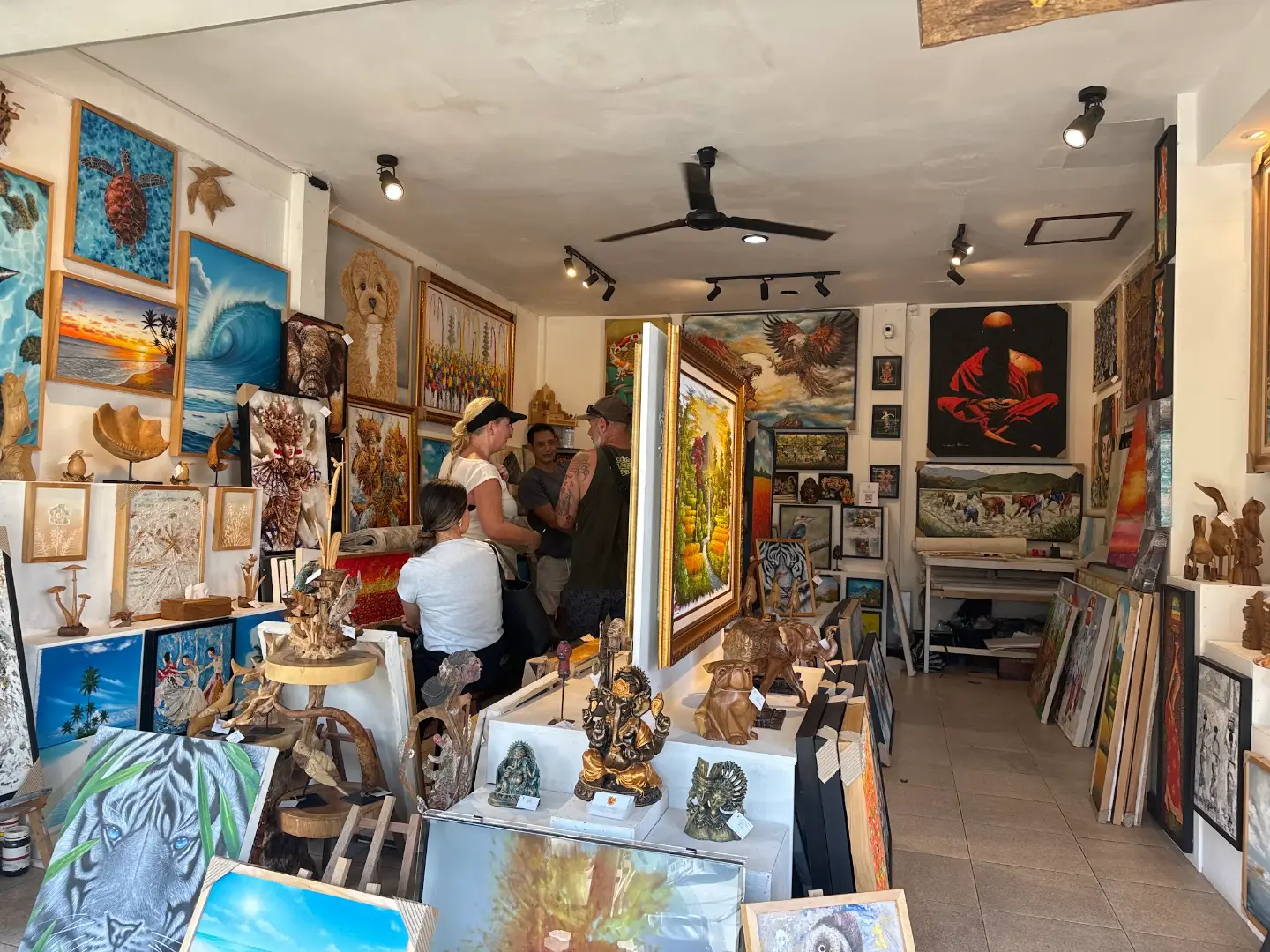 Visitors browsing the painting and woodcarving collection at Arts of Bali gallery, Seminyak
