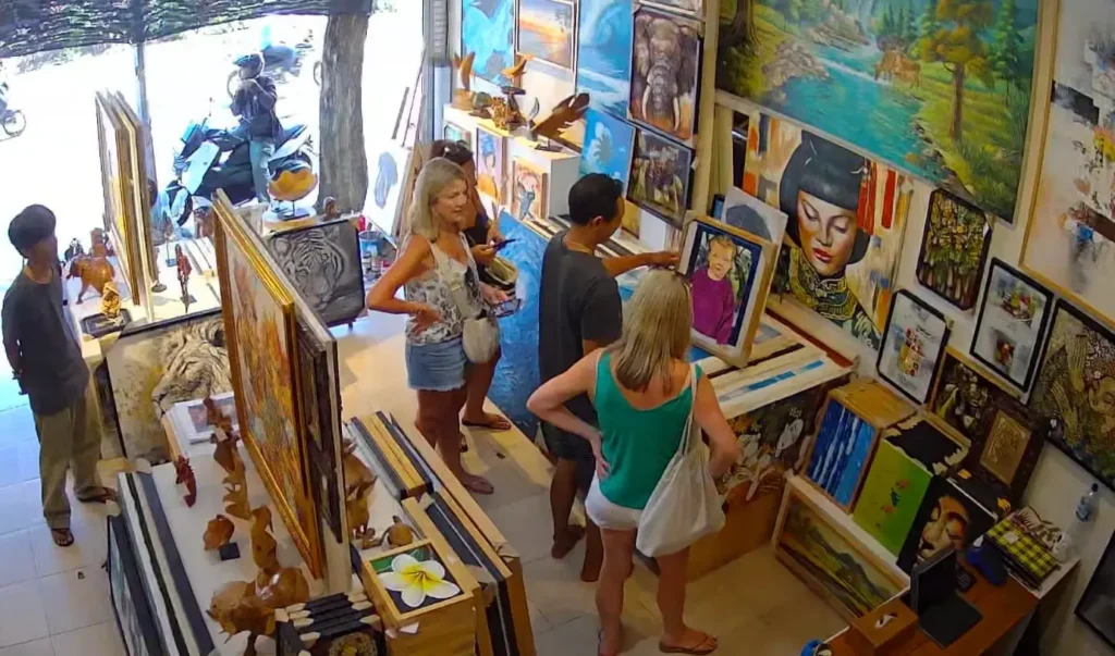 Tourists browsing original Balinese paintings inside Arts of Bali gallery, Seminyak
