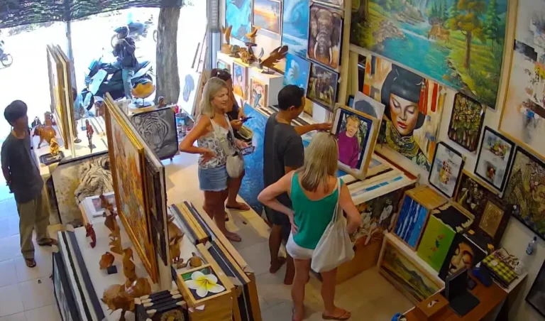 Tourists browsing original Balinese paintings inside Arts of Bali gallery, Seminyak