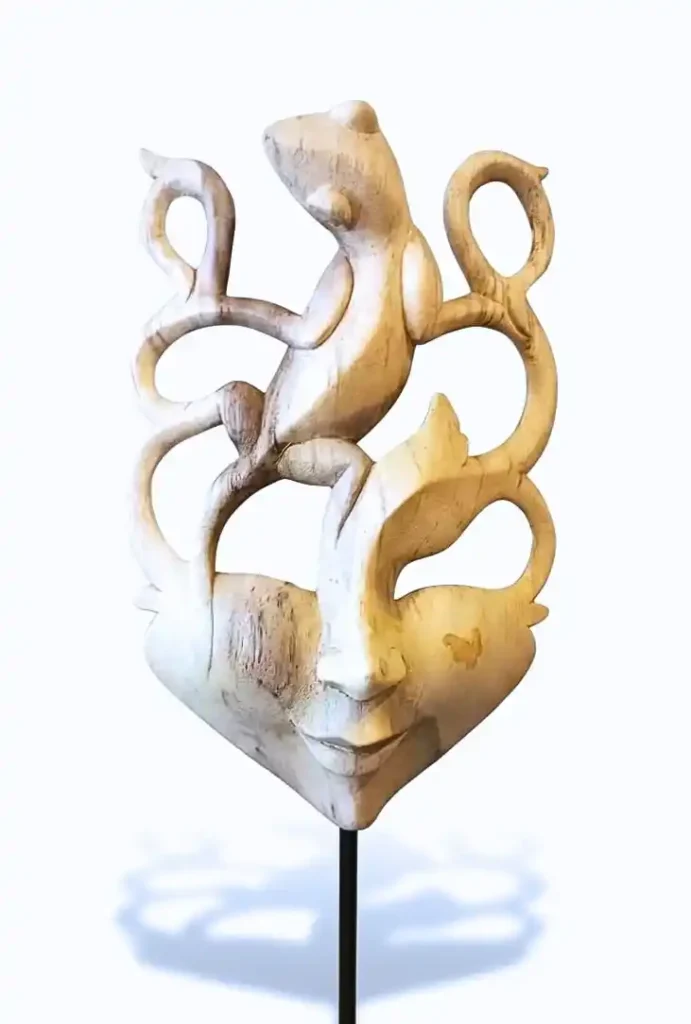 Hand-carved blonde wood Balinese angel mask sculpture on metal stand from Arts of Bali.