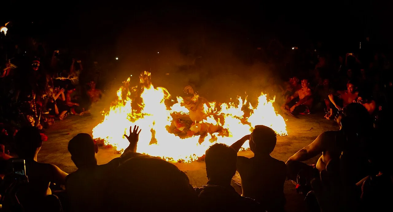Kecak fire dance at Uluwatu with Hanuman sitting inside a ring of fire and the audience around it